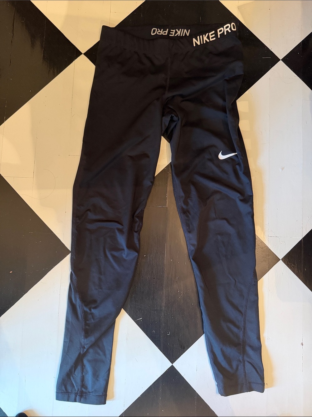 Nike Black women’s Performance Leggings with White Swoosh